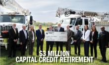 A photo of the Board of Directors holding a big check with $3 Million on it