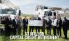 A photo of the Board of Directors holding a big check with $3 Million on it