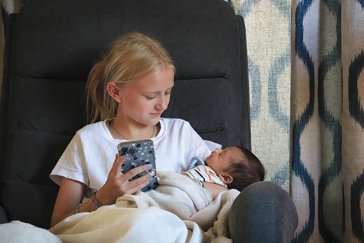 Camdyn Tribbett enjoying hi-speed internet and 'baby time' with her nephew.